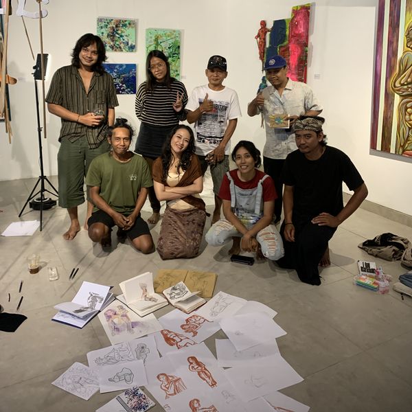 Artists and friends gathered in the Hyang Tresna gallery, with their sketches spread across the floor