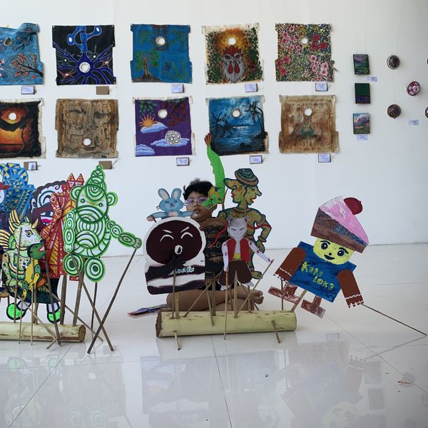 A row of finished, hand-painted wayang puppets